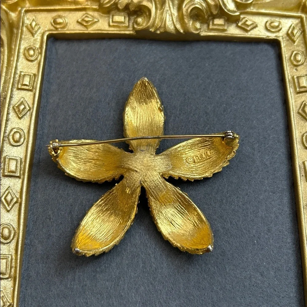 Vintage BSK gold-tone textured flower brooch with a faux pearl center.
